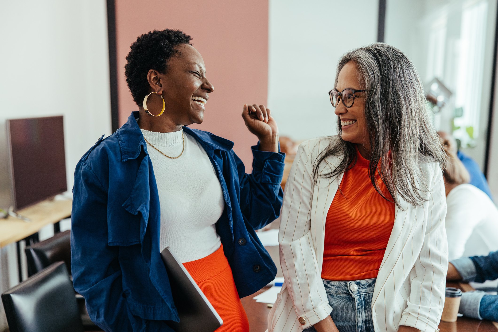 Two Business Professionals Laughing at the Office